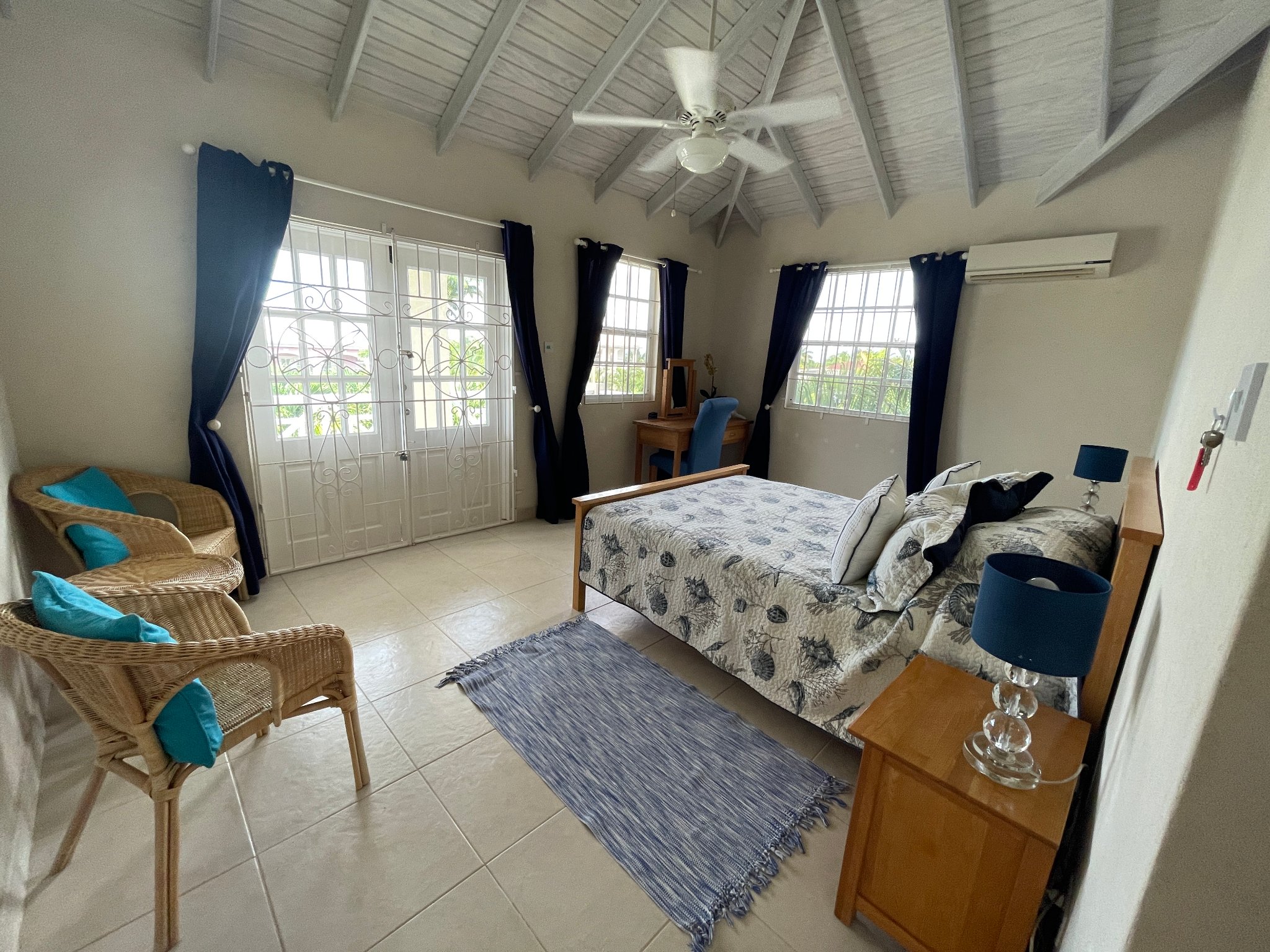 Holland Park Villa master bedroom with tropical artwork and walk-in wardrobe